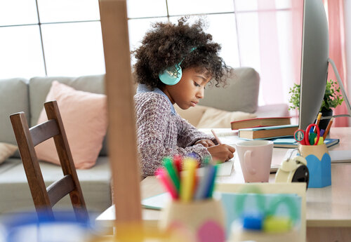 african-school-kid-girl-wearing-headphones-virtual-KLQND59